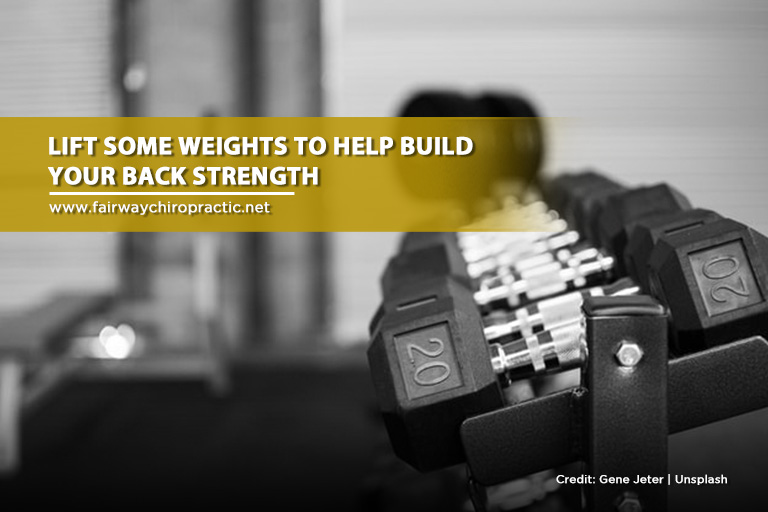 Lift some weights to help build your back strength